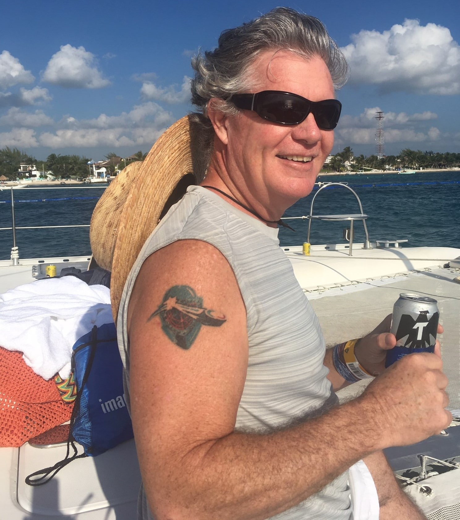 Man on boat, a drink, the coral reefs