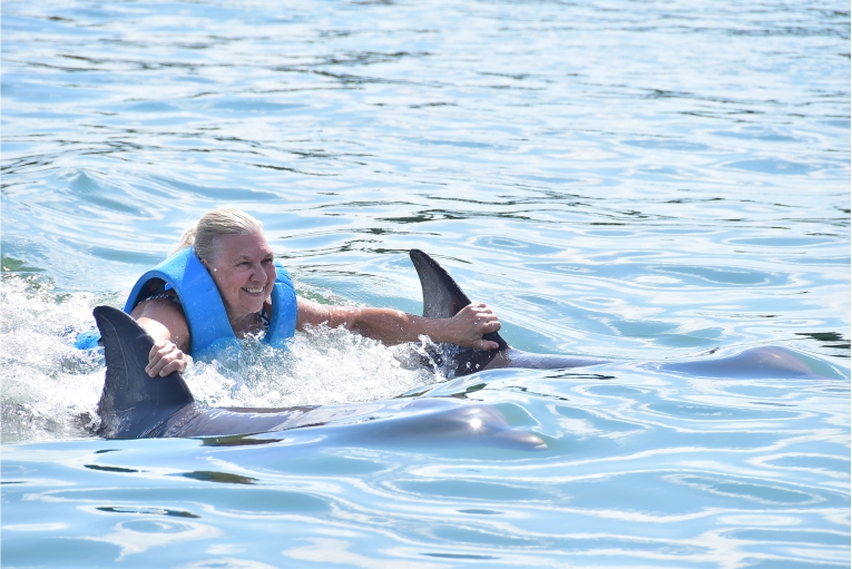 woman riding dolphin
