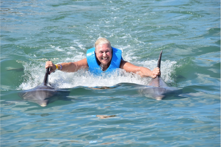 Woman riding dolphin