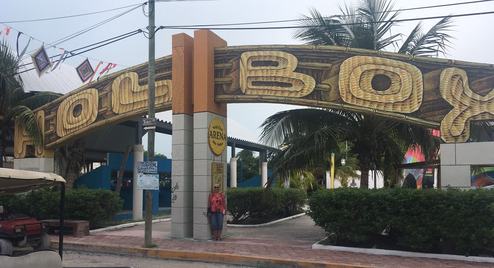 Woman standing in front of Holbox Sign